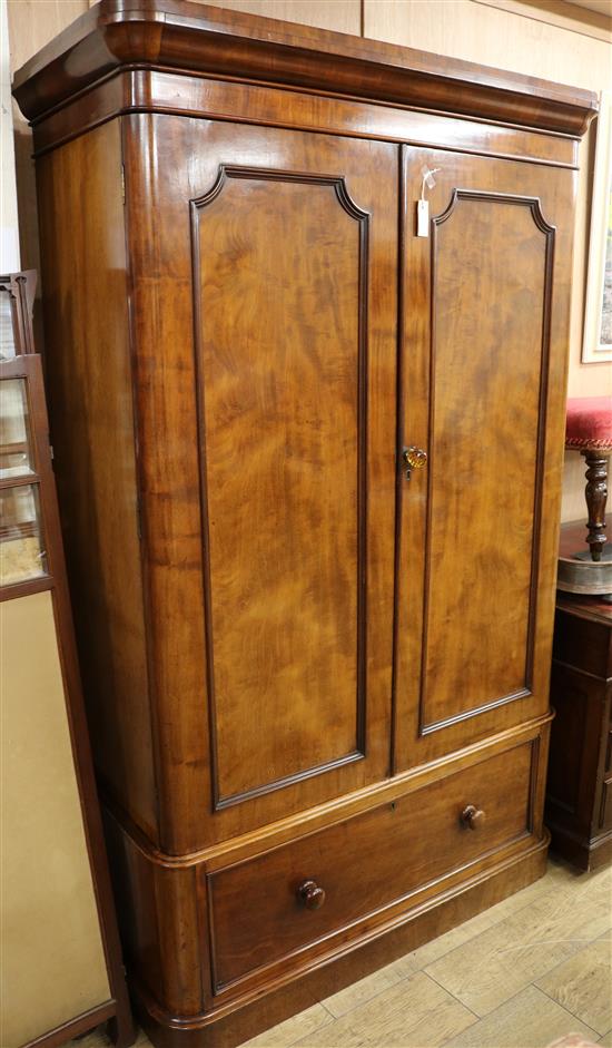 A Victorian mahogany wardrobe, with moulded cornice, fitted two panelled doors and with a drawer below, W.3ft 8in., H.204cm